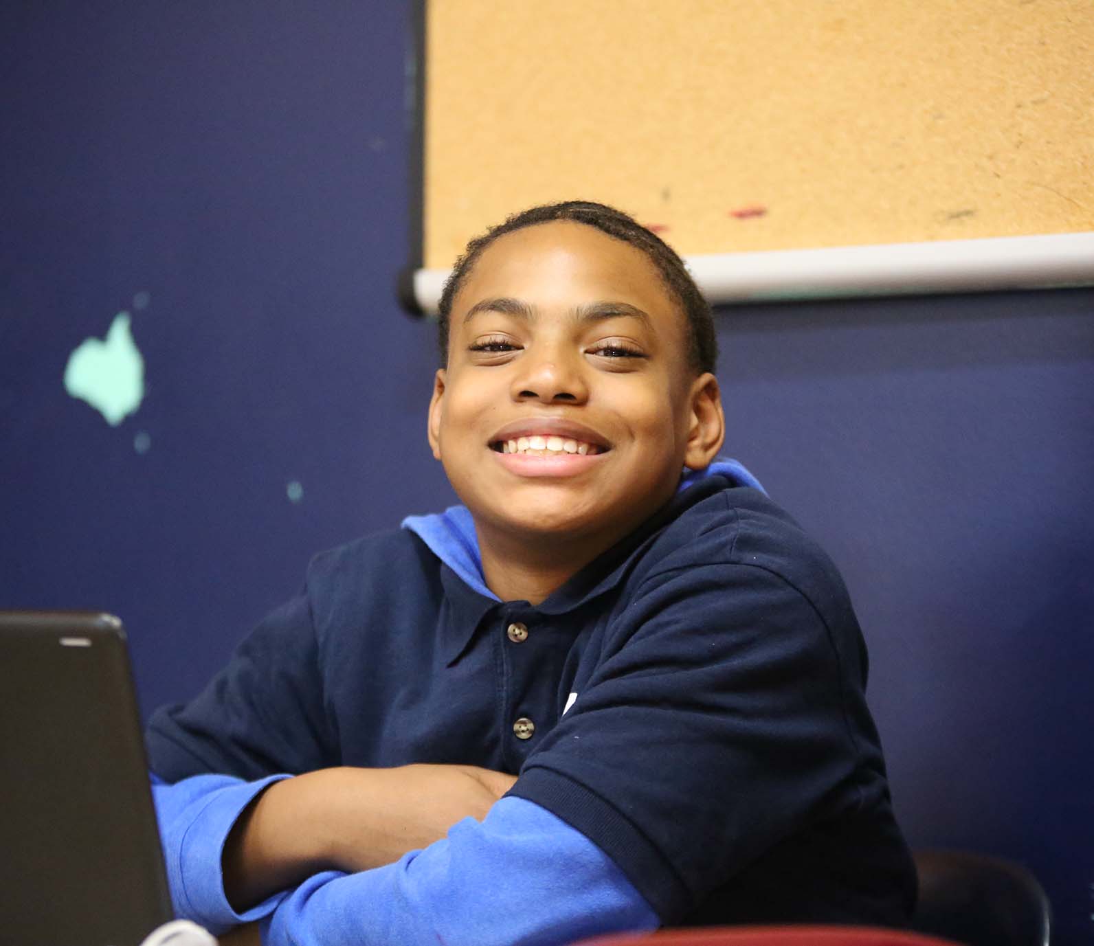 Horizon Science Academy Dayton High student wearing headphones uses a laptop in class